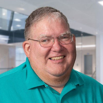 Jerry Borton: Man with graying hair, trimmed goatee, glasses, and checked button down shirt