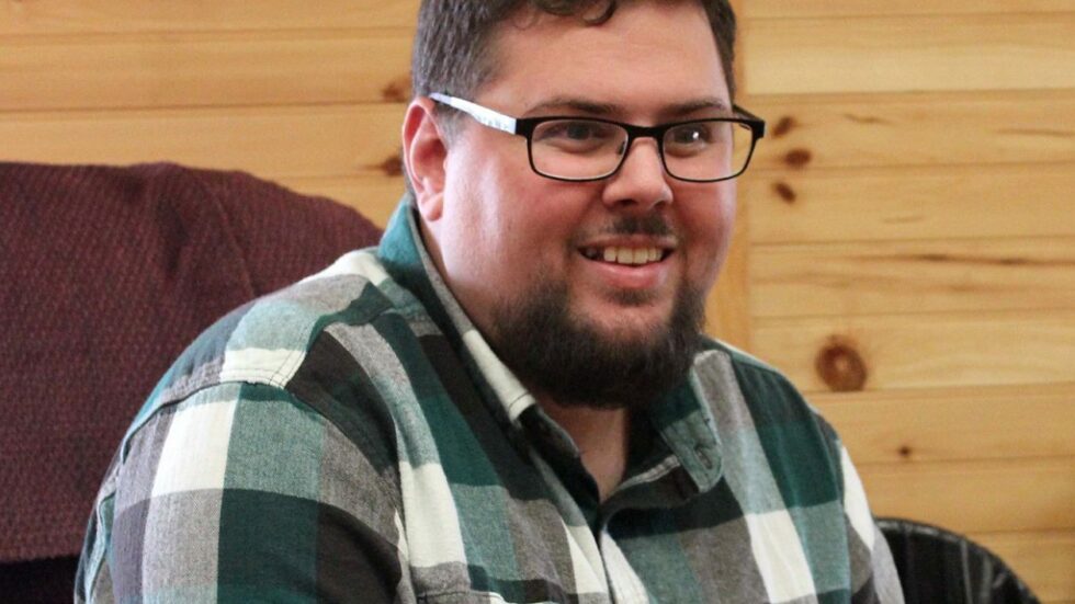 Matt smiling.  He's got a goatee and glasses, and is wearing a green and gray plaid button down