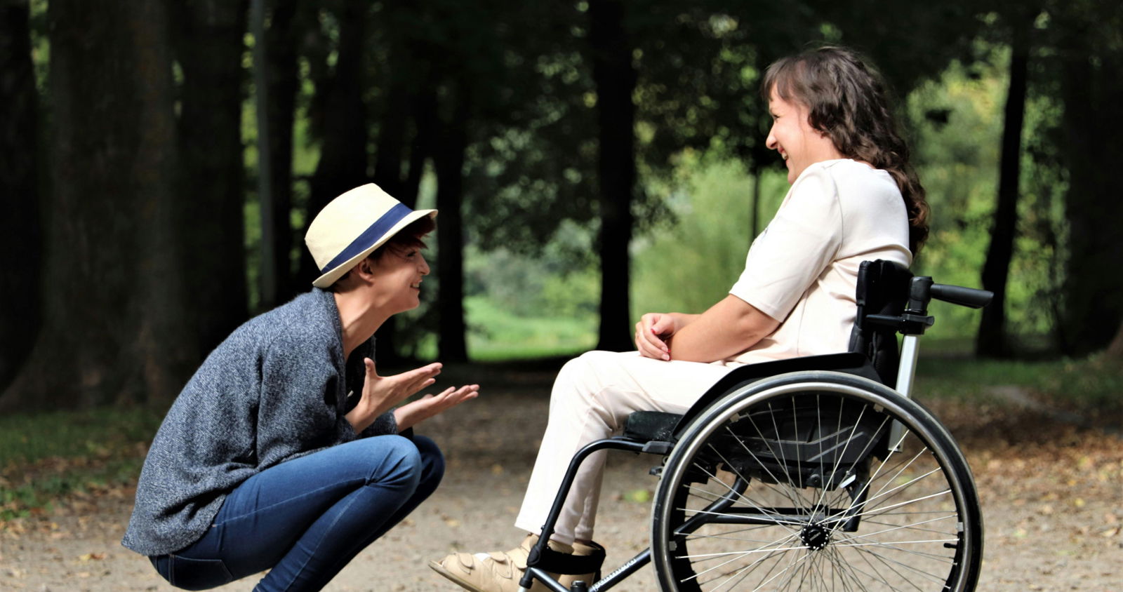Two people talking and one is in a wheelchair