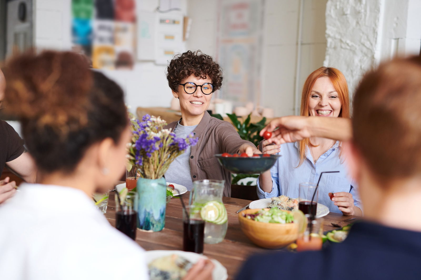 People passing food at the table